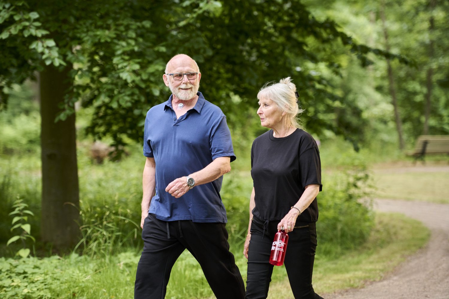 Couple walking outside man using atos energy hme for stoma