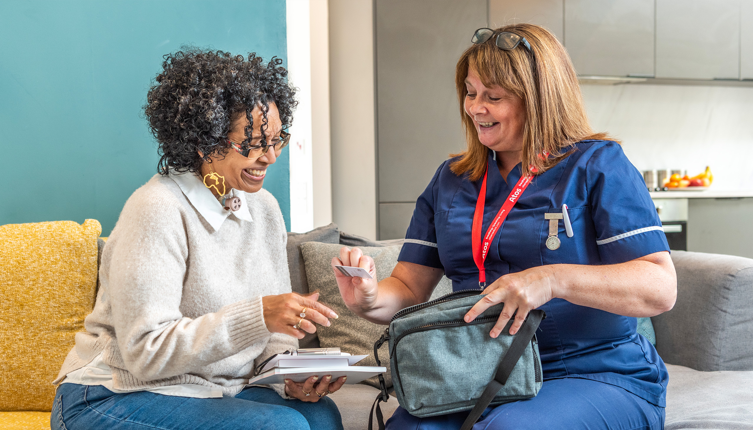 nurse giving woman with tracheostomy a card